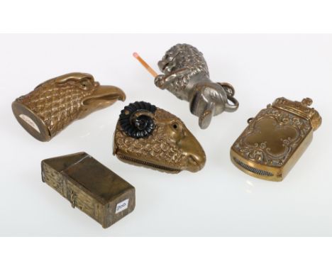 Five novelty pressed brass vesta cases, in the form of a latrine, lion, eagle, ram and crowned cushion, largest 7cm.