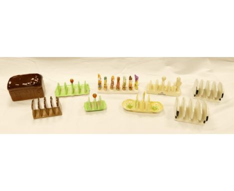 A collection of Carltonware toast racks including snow white &amp; seven dwarfs, Lurpac, Hovis etc 