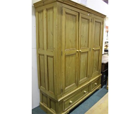 Pine wardrobe, the triple wardrobe with three panel doors above one long and one short drawer