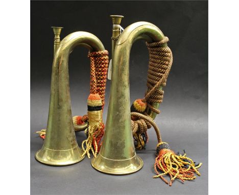 Two replica British 1855 pattern B flat bugles in brass with replica bugle cords, (2)