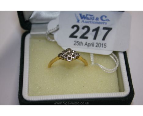 An 18ct Gold, Platinum set Diamond Ring with nine stones in diamond shape