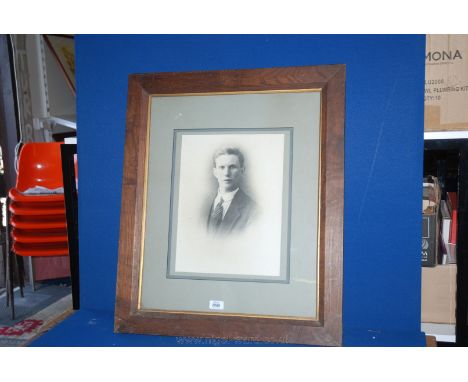 A large wooden frame Print of black and white photograph of a young man