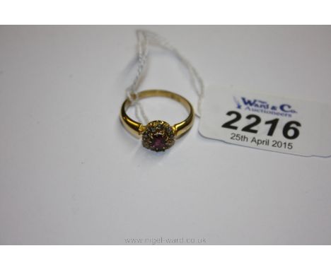 An 18ct Gold Ruby and Diamond Ring, having nine diamonds surrounding central ruby