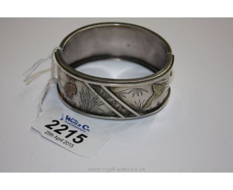 A wide Silver Bangle decorated in oriental style with birds and foliage, marked 'standard'