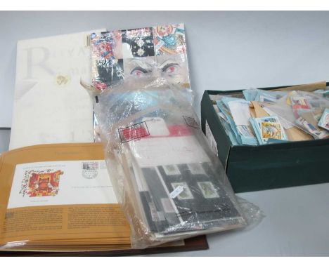Stamps; A collection of World stamps in packets, first day covers, housed in a special cover album, plus two Royal Mail 'Year
