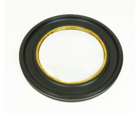 A Regency style circular convex wall mirror with a parcel gilt and ebonised frame, 73cm in diameter.