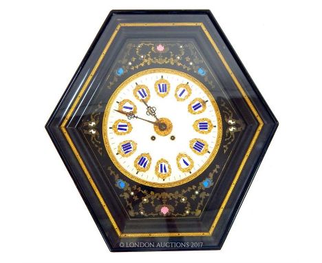 An ebonised hexagonal wall clock, having a circular alabaster dial mounted with enamelled Roman numerals surrounded by emboss