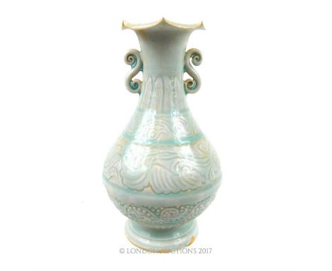 A Chinese, Song-style, celadon, glazed vase with a bulbous body incised all over with floral decoration, two 's'-scroll handl
