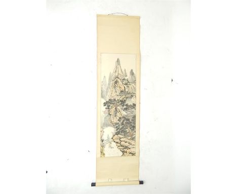 A 20th century, Chinese, hand-painted scroll depicting a rocky, craggy, mountainous landscape with a dwelling in the middle-g