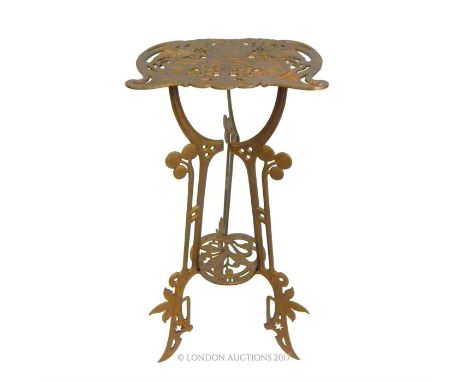 An Art Nouveau style, metal, jardiniere stand constructed of two pierced shelves attached to splayed, tri-pod legs, the entir