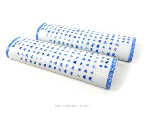 Two Chinese, ceramic paper weights /scroll weights in an elongated form, the tops adorned with neat rows of blue, hand-painte