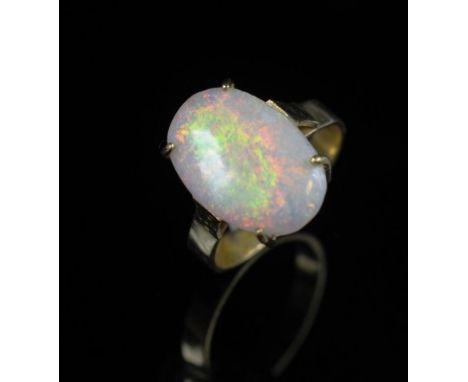 Opal and 18ct yellow gold ring marked 18ct. Approx solid white opal 11mm x 16mm, ring size Q, weight 4.3 grams