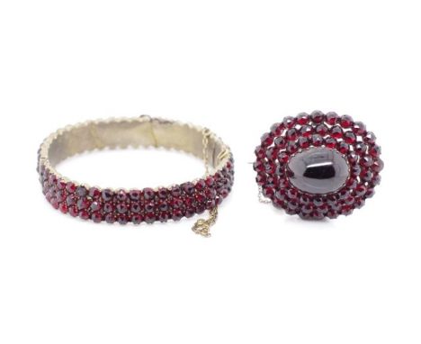 Antique garnet brooch and bangle the brooch is set in silver and the bangle in gilt metal. Approx brooch size 32mm x 37mm, in