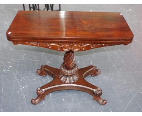 19th century rosewood card table top opens to leather covered playing surface, to carved apron, on turned central column, on 