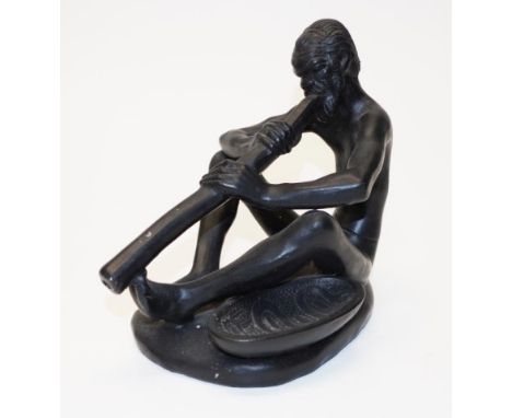 Takacs Australia ceramic figure seated Aboriginal man playing a didgeridoo, inscribed mark to base, circa 1950s, (height 20cm