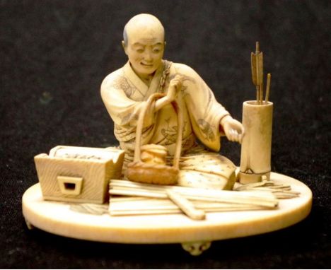 Meiji Japanese carved ivory seated Fletcher figure seated man at work, with intricately carved tools surrounding him, signed 