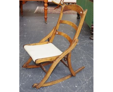 Vintage folding wood rocking chair upholstered seat.