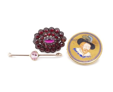 Three antique and vintage brooches includes a antique gold and pink glass bar brooch and a bohemian garnet set gold brooch. (