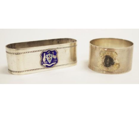 Two various sterling silver napkin rings including napkin ring with applied enamel coat of arms, and cased napkin ring with b