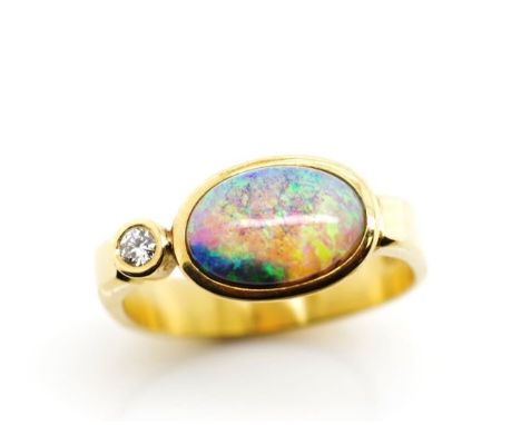 Opal and diamond set 18ct yellow gold ring marked K18. Approx weight 4.7 grams, ring size M, opal cabochon size 9.5mm x 6.8mm