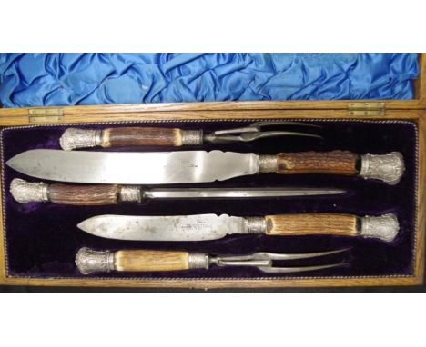 Good Victorian wood cased carving set including 2 carving knives, and 2 carving forks, each with antler handle, and sterling 