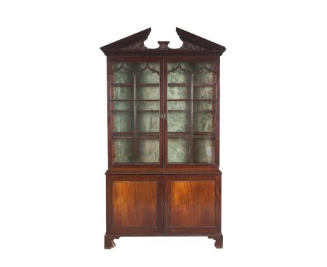 A FINE GEORGE III MAHOGANY BOOKCASE, in the manner of Thomas Chippendale, the open triangular pediment with dentil moulding a