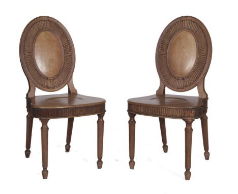 A PAIR OF GEORGE III MAHOGANY FRAMED COMPASS FRONTED HALL CHAIRS, with panel seats and oval fluted backs on fluted tapering l
