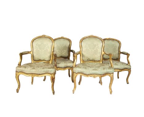 A SET OF FOUR LOUIS XVI GILTWOOD FAUTEUILS, en cabriolet, covered in light blue silk damask, with floral carved cresting, ser