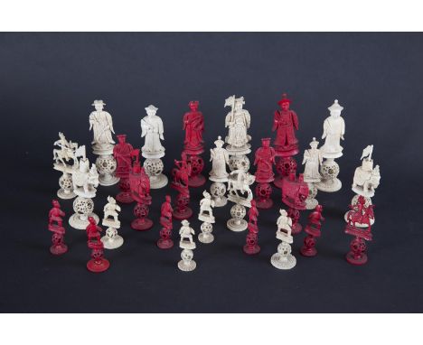 A CHINESE STAINED AND NATURAL IVORY CHESS SET, c.1860, each figure standing on puzzle balls and lotus pod bases, the king and