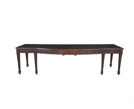 A GEORGE III MAHOGANY RECTANGULAR BOWFRONT SIDE TABLE IN THE MANNER OF THOMAS CHIPPENDALE, the plain top raised above a flute