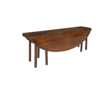 A LATE GEORGE III MAHOGANY HUNTING TABLE, the plain double drop leaf top raised on chamfered square gate legs. 205cm long