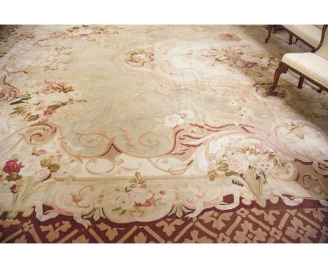 ***PLEASE NOTE THIS LOT IS INCORRECTLY ILLUSTRATED IN PRINTED CATALOGUE*** A LARGE AUBUSSON CARPET, the ivory field decorated