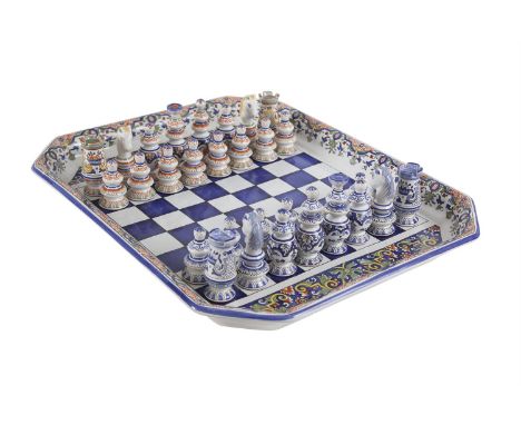 A 20TH CENTURY FRENCH FAIENCE POTTERY CHESS SET AND BOARD, with handpainted decorated, one side blue and white, the other pai