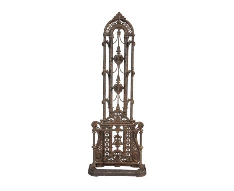 A VICTORIAN CAST IRON HALL STAND with arched pierced back above a stick stand base.