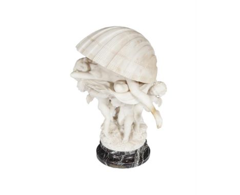 AN ITALIAN CARVED ALABASTER MODEL OF VENUS, resting in an open shell, supported by winged putti on a naturalistic circular ba