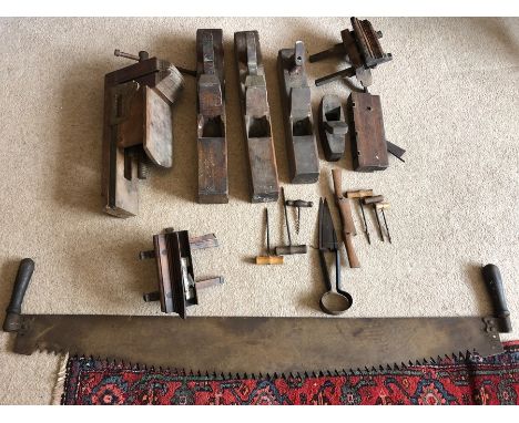 A quantity of vintage tools including block planes, bradawls, wooden bench vice and log saw. 