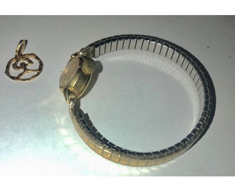 Ladies 18 carat gold Rotary Maximus wristwatch on yellow metal strap together with charm, marked .750