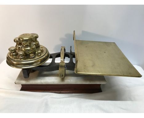 Victorian brass and iron grocer's scales on marble plinth and wooden base complete with full set of brass weights. 51cms w. 