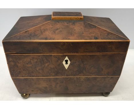 Early 19thC sarcophagus shaped tea caddy in burr yew, ivory escutcheons, ring handles to side.    