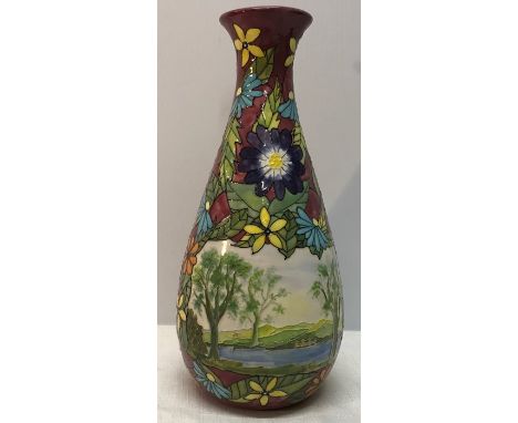 A Jean Coales hand decorated pottery vase, 28cms h, using tube lining in vibrant colours, floral images with a Lakeland scene