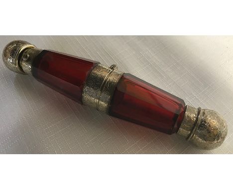 Ruby glass white metal mounted double end scent bottle with central hinged compartment. Approx length 14.5cms. 