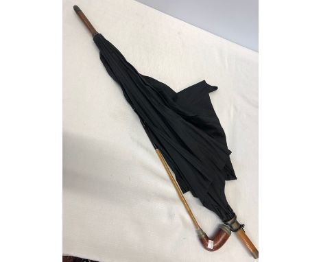 A late 19thC umbrella by A.Wrigley umbrella makers Hull, converts into a walking stick, also contains a pipe. 