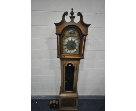 AN OAK EIGHT DAY CHIMING LONGCASE CLOCK, the hood with a swan neck pediment, fluted Corinthian pillars flanking a glazed door