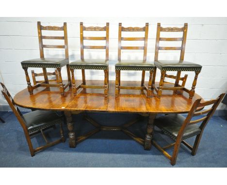 A GOOD REPRODUCTION OAK EXTENDING DINING TABLE, with rounded ends, two additional leaves, on four turned and block supports u