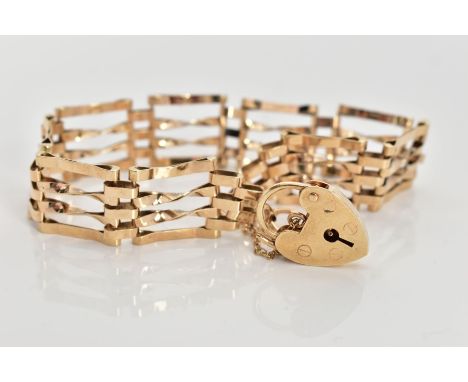 A 9CT GOLD GATE BRACELET,  four bar polished yellow gold gate bracelet, fitted with a heart padlock and safety chain, approxi