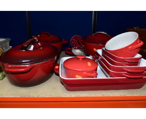 A GROUP OF RED KITCHENAID COOKWARES, twelve pieces comprising an enamel oval casserole dish, internal measurements 23cm x 28.