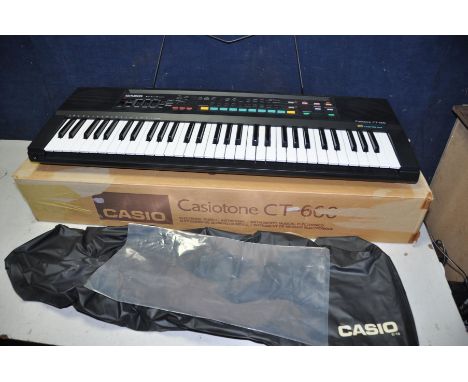 A CASIOTONE CT-660 electronic keyboard with original box and instruction manual and a Shark 2in1 pocket mop professional (bot