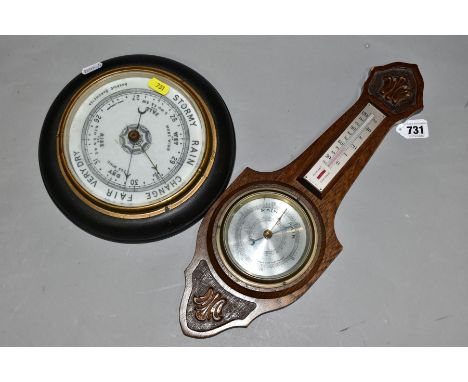 A CIRCULAR OAK CASED ANEROID BAROMETER, approximate diameter 23cm, together with an oak thermometer barometer approximate len