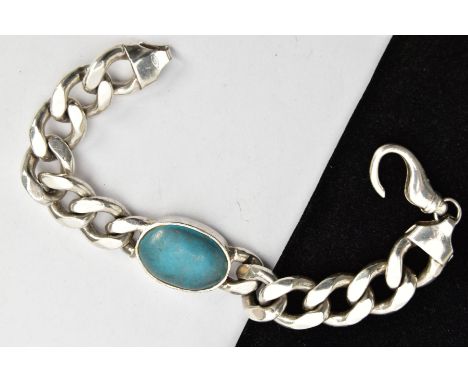 A HEAVY SILVER BRACELET, centring on an oval turquoise colour cabochon, bezel set fitted to a wide and heavy curb link bracel