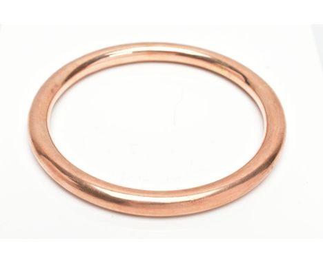 A ROSE GOLD TONE ARM BANGLE, plain polished rose gold design, stamped '9ct PPLd', approximate internal width 83.7mm, approxim